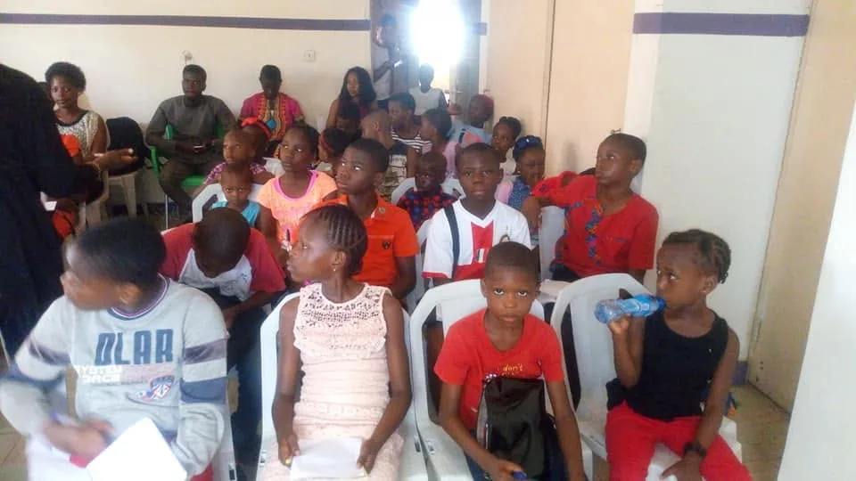 Teenagers seated together during a club session.