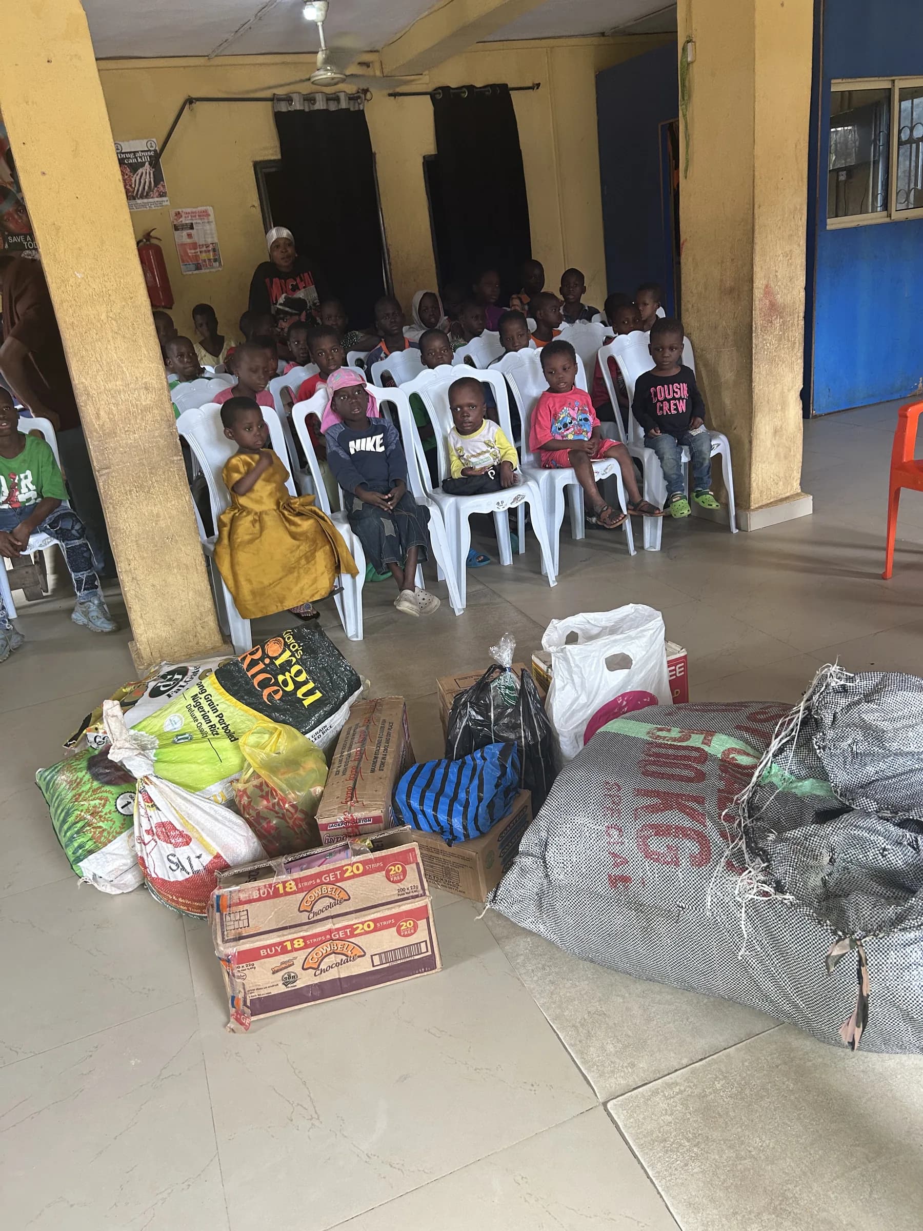 Volunteers carrying donated supplies into the orphanage.