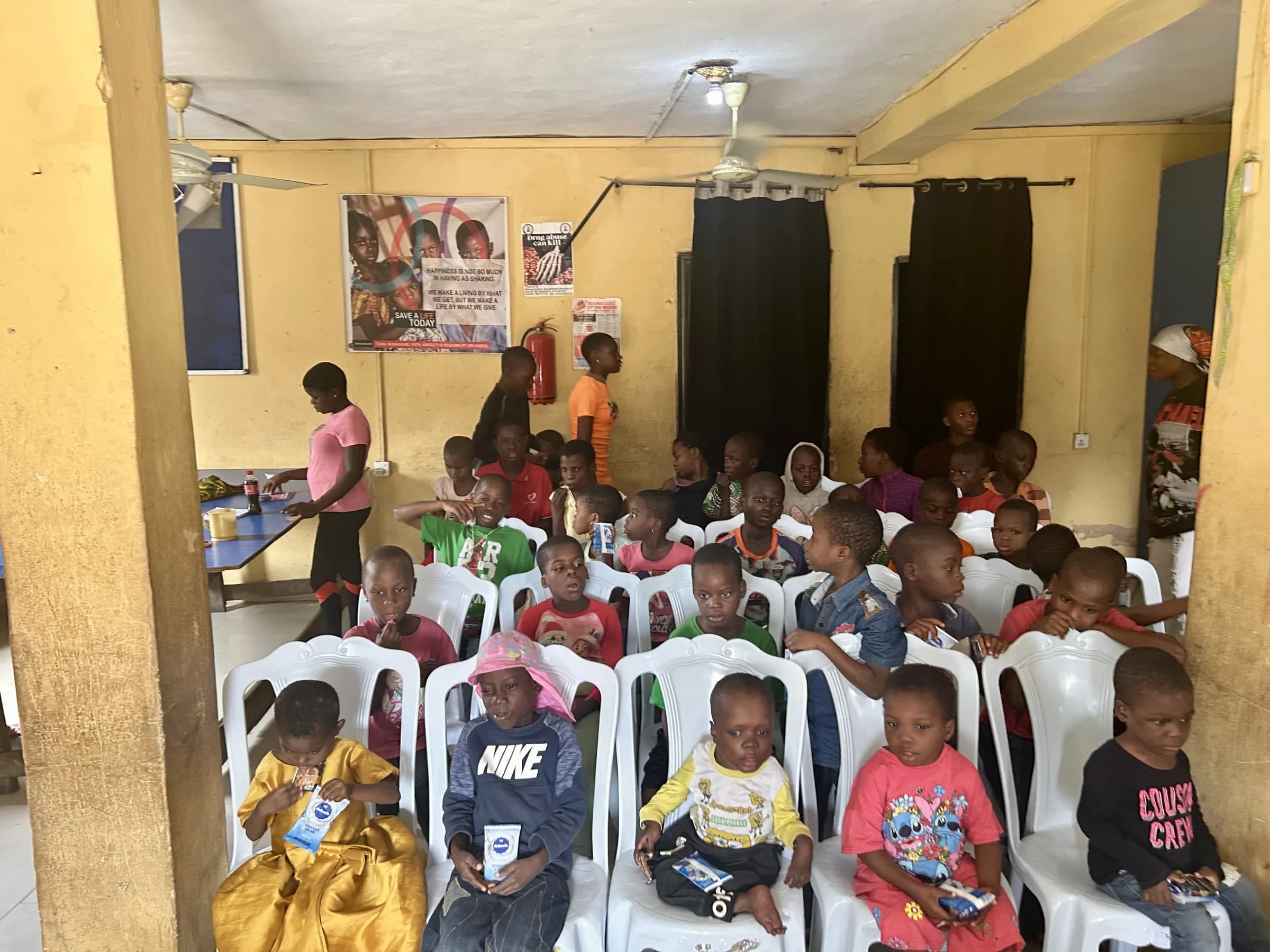Children seated together in the hall at Amadin Orphanage during the outreach.
