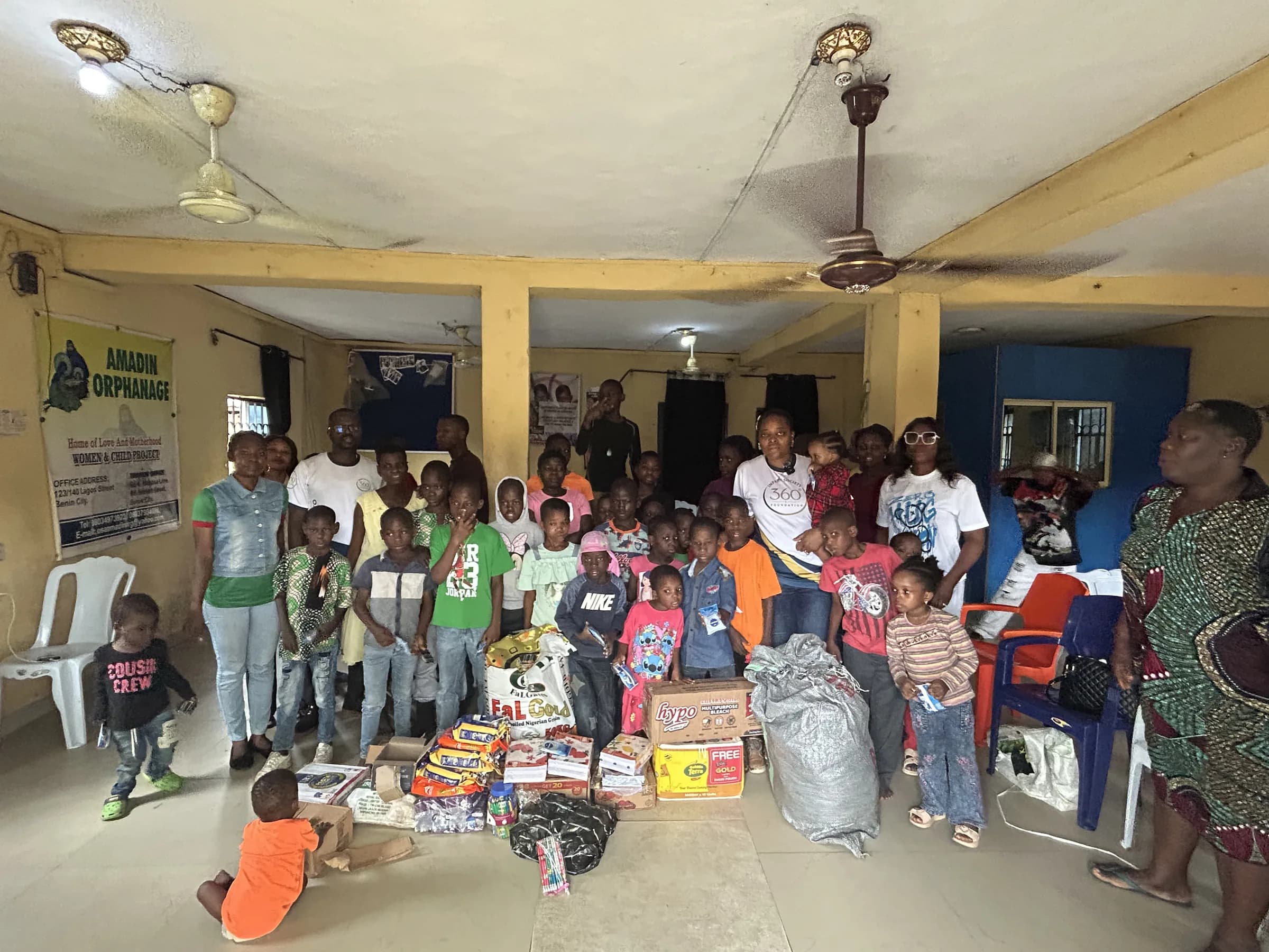 Children gathered around the donated supplies at Amadin Orphanage.