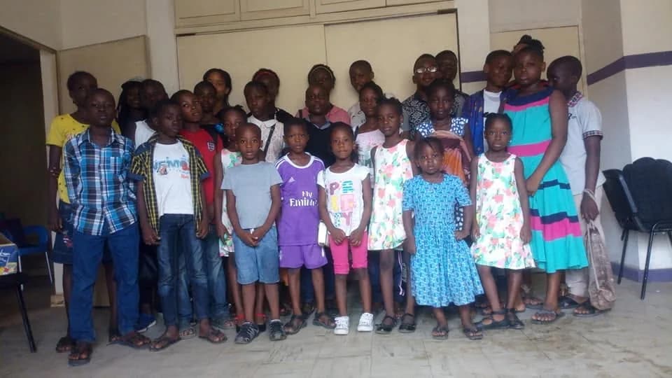 Children gathered with facilitators at a club session.