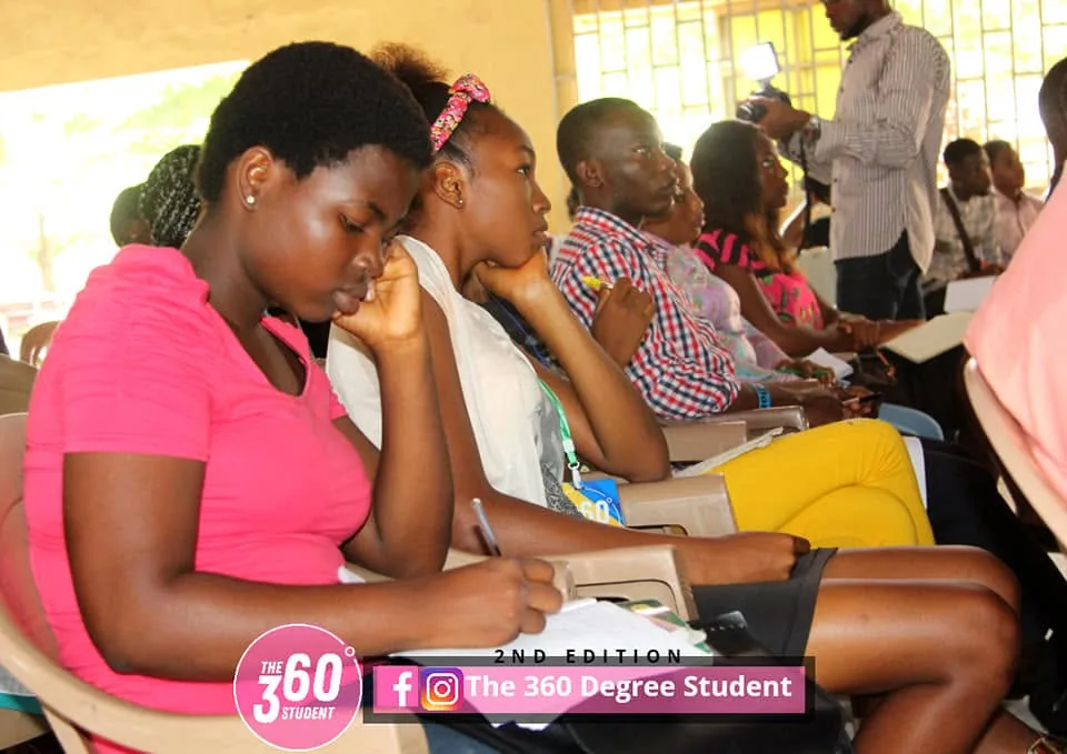 A student listening closely during a conference session.