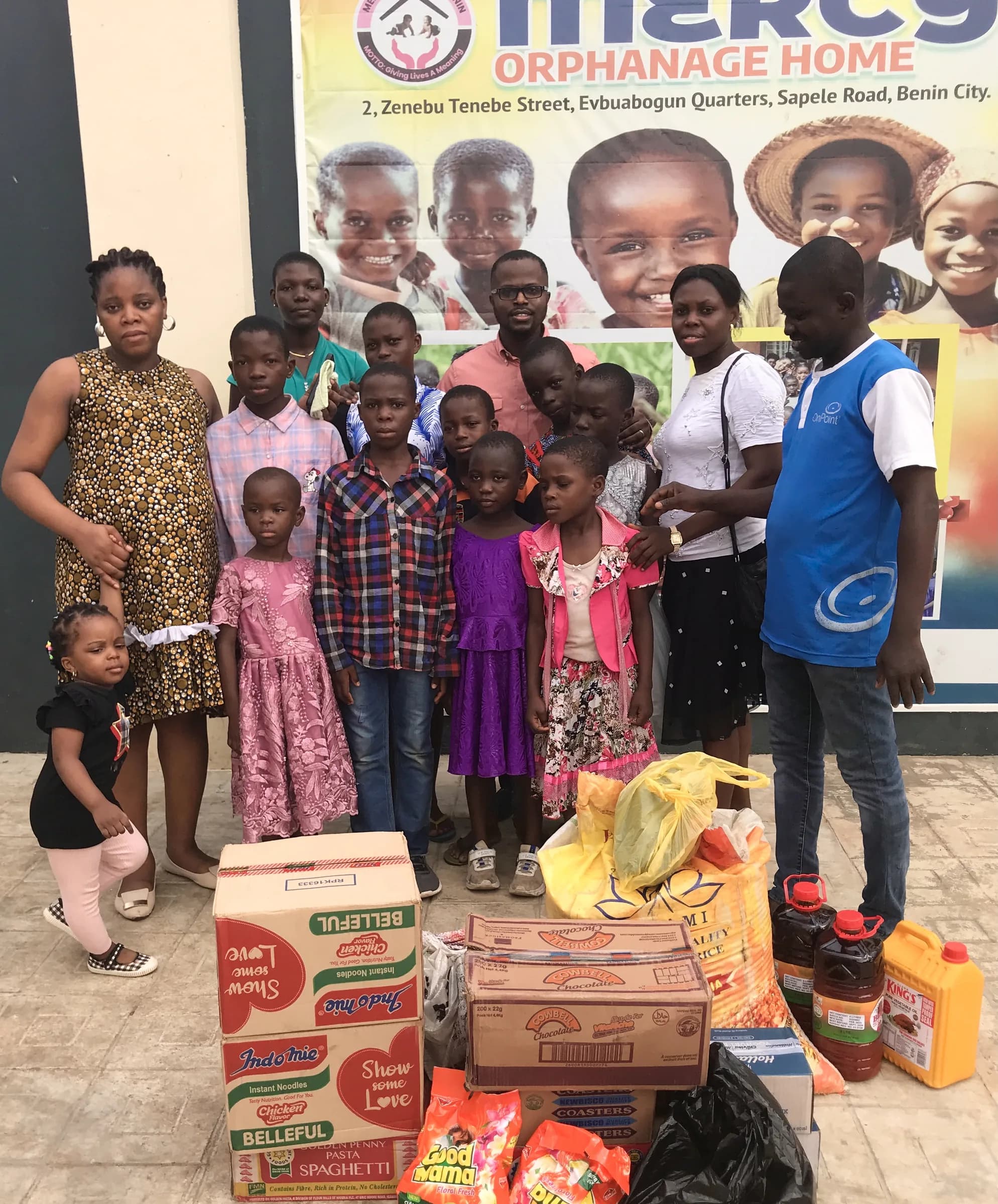 Children at Mercy Orphanage Home with a volunteer and donated supplies.